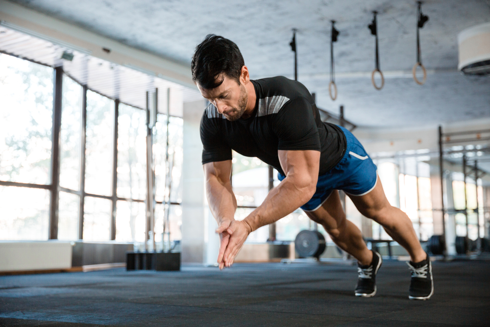 Sportsman,Wearing,Blue,Shorts,And,Black,T-shirt,Doing,Push-up,With